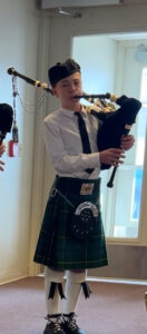 Bagpiper performing indoors at memorial service