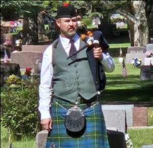 Solo bagpiper waiting to perform at Memorial Day service in Wyoming