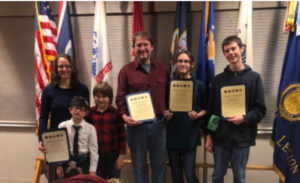 Pipe band members receiving award from local VFW