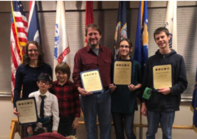 Pipe band members receiving award from local VFW