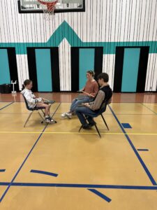 Advanced Pipe Band youth teaching beginner drumming student