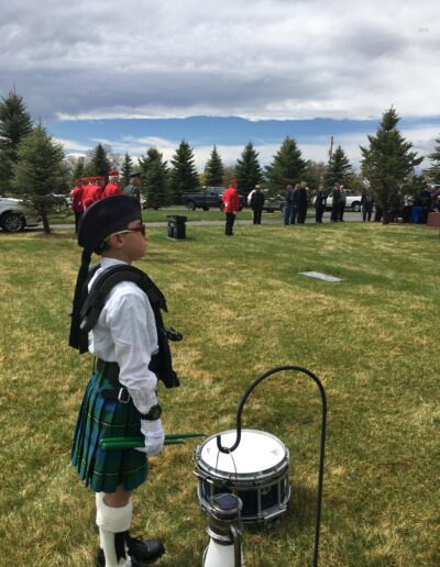 Young drummer standing at attention at a Veteran Graveside memorial